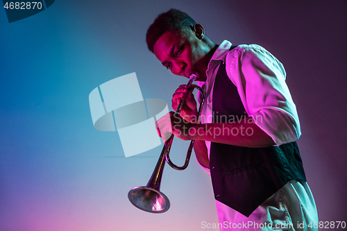 Image of African American jazz musician playing trumpet.