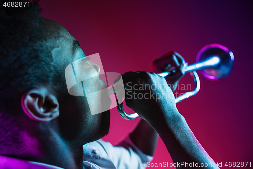 Image of African American jazz musician playing trumpet.