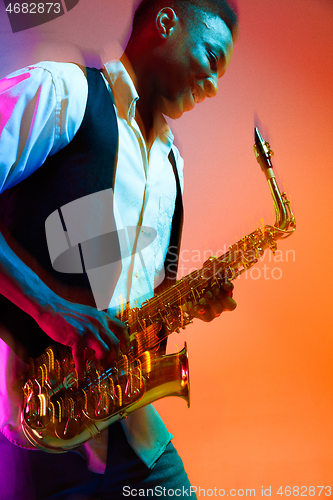 Image of African American jazz musician playing the saxophone.