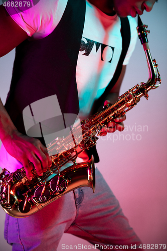 Image of African American jazz musician playing the saxophone.