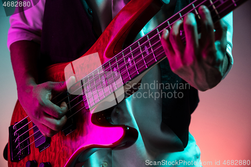 Image of African American jazz musician playing bass guitar.