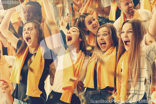 Image of Group of happy fans are cheering for their team victory.