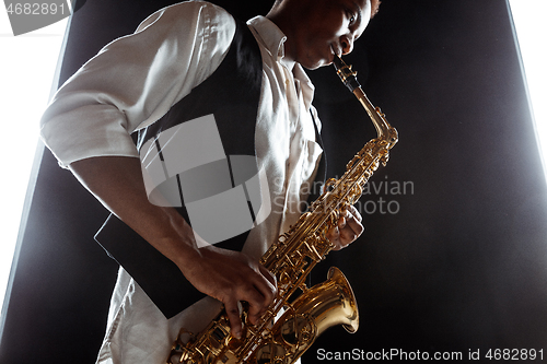 Image of African American jazz musician playing the saxophone.