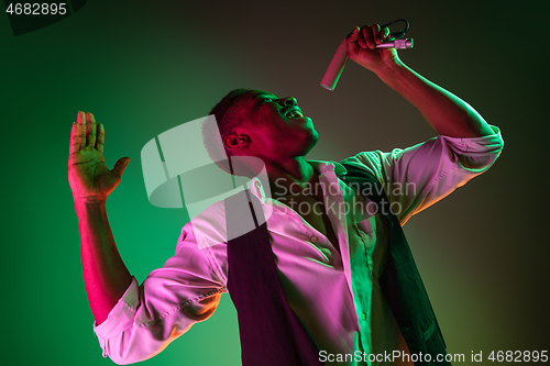 Image of African American handsome jazz musician singing.