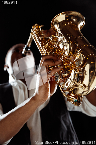 Image of African American jazz musician playing the saxophone.