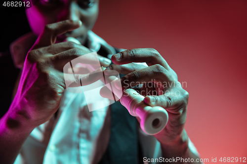 Image of African American jazz musician playing pipe.