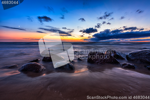 Image of Sea sunset seascape with wet rocks