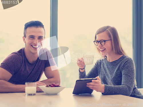 Image of couple enjoying morning coffee and strawberries