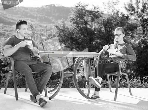 Image of couple enjoying morning coffee and breakfast