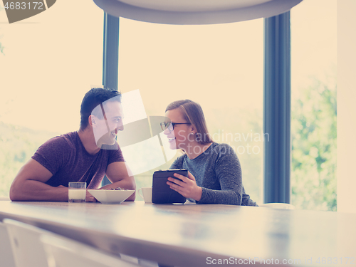 Image of couple enjoying morning coffee and strawberries