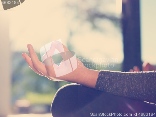 Image of young woman doing morning yoga exercises