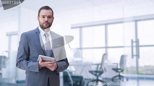 Image of Young businessman in his office