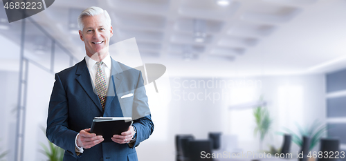 Image of Senior businessman in his office