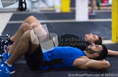 Image of young athletes lying on the floor and relaxing