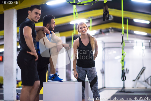 Image of athletes working out  jumping on fit box