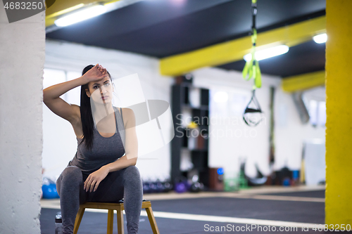 Image of young athlete woman sitting and relaxing