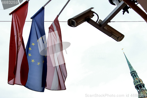 Image of Flags, camcoder and church in Riga.