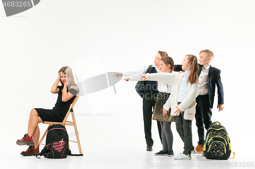 Image of Little girl sitting alone on chair and suffering an act of bullying.