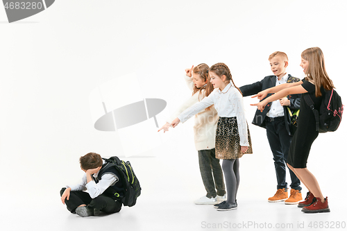 Image of Little boy sitting alone on floor and suffering an act of bullying.