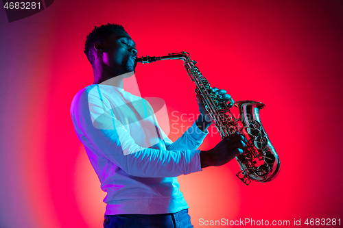 Image of African American jazz musician playing the saxophone.