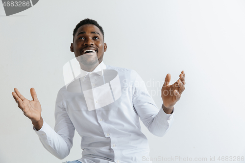 Image of Portrait of excited young African American male screaming in shock and amazement.