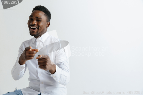 Image of Afro american man over isolated grey background pointing with finger to the camera and to you, hand sign, positive and confident gesture from the front