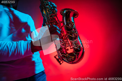 Image of African American jazz musician playing the saxophone.