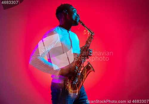 Image of African American jazz musician playing the saxophone.