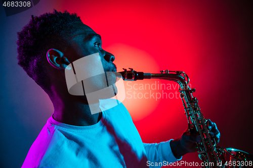 Image of African American jazz musician playing the saxophone.