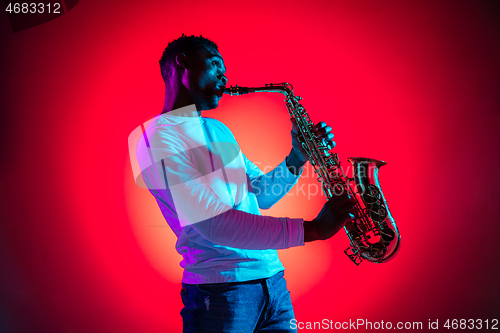 Image of African American jazz musician playing the saxophone.