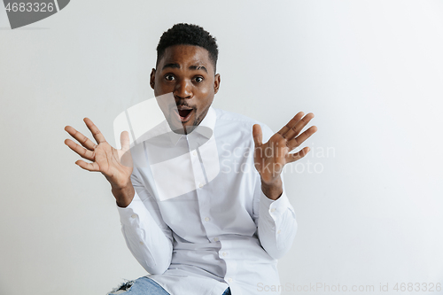 Image of Portrait of excited young African American male screaming in shock and amazement.