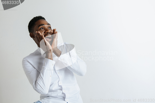 Image of Portrait of excited young African American male screaming in shock and amazement.