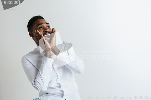 Image of Portrait of excited young African American male screaming in shock and amazement.