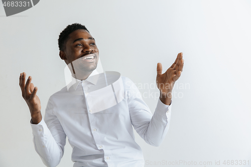 Image of Portrait of excited young African American male screaming in shock and amazement.