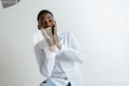 Image of Portrait of excited young African American male screaming in shock and amazement.