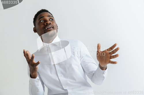 Image of Portrait of excited young African American male screaming in shock and amazement.