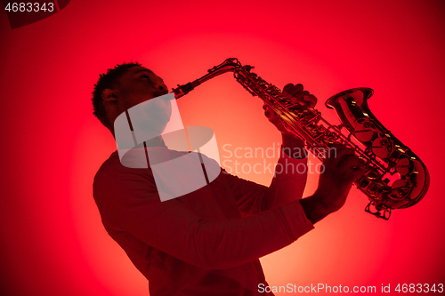 Image of African American jazz musician playing the saxophone.