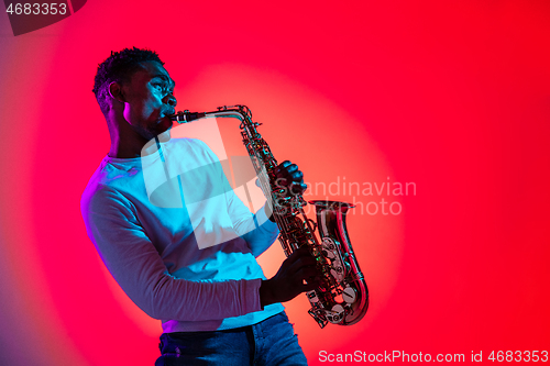 Image of African American jazz musician playing the saxophone.