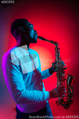 Image of African American jazz musician playing the saxophone.