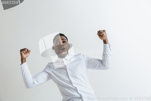 Image of Portrait of excited young African American male screaming in shock and amazement.