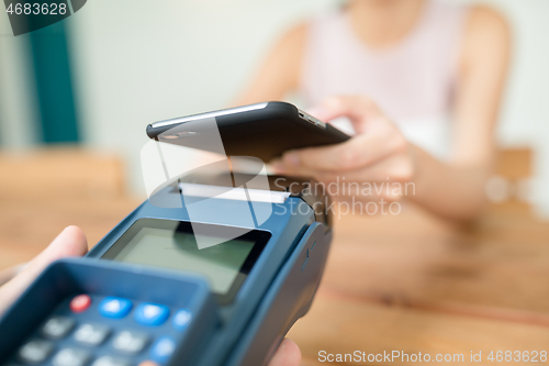 Image of Female pay on cellphone