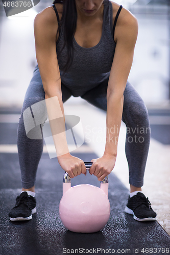 Image of woman exercise with fitness kettlebell