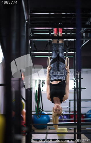 Image of woman working out on gymnastic rings