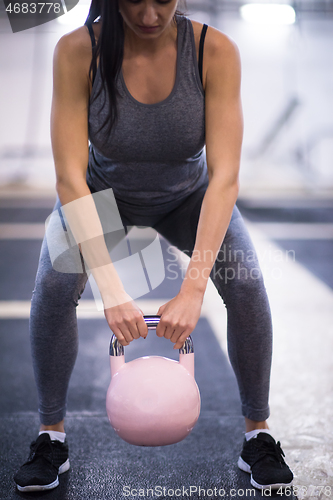 Image of woman exercise with fitness kettlebell