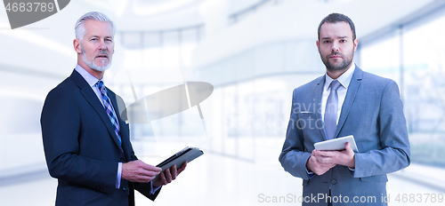 Image of Portrait of two colleague businessmans