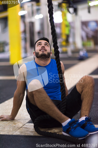 Image of man relaxing before rope climbing