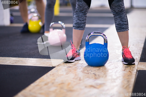 Image of athletes doing exercises with kettlebells