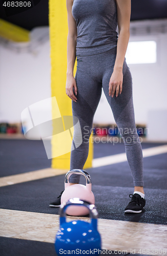 Image of woman exercise with fitness kettlebell