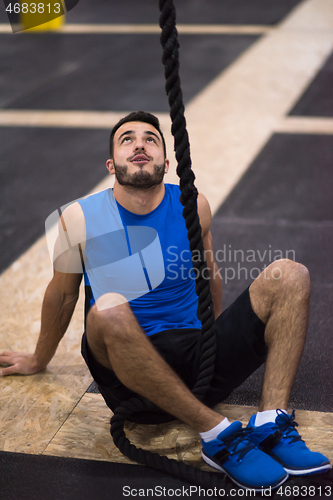 Image of man relaxing before rope climbing