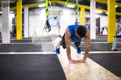 Image of Young  man doing pushups